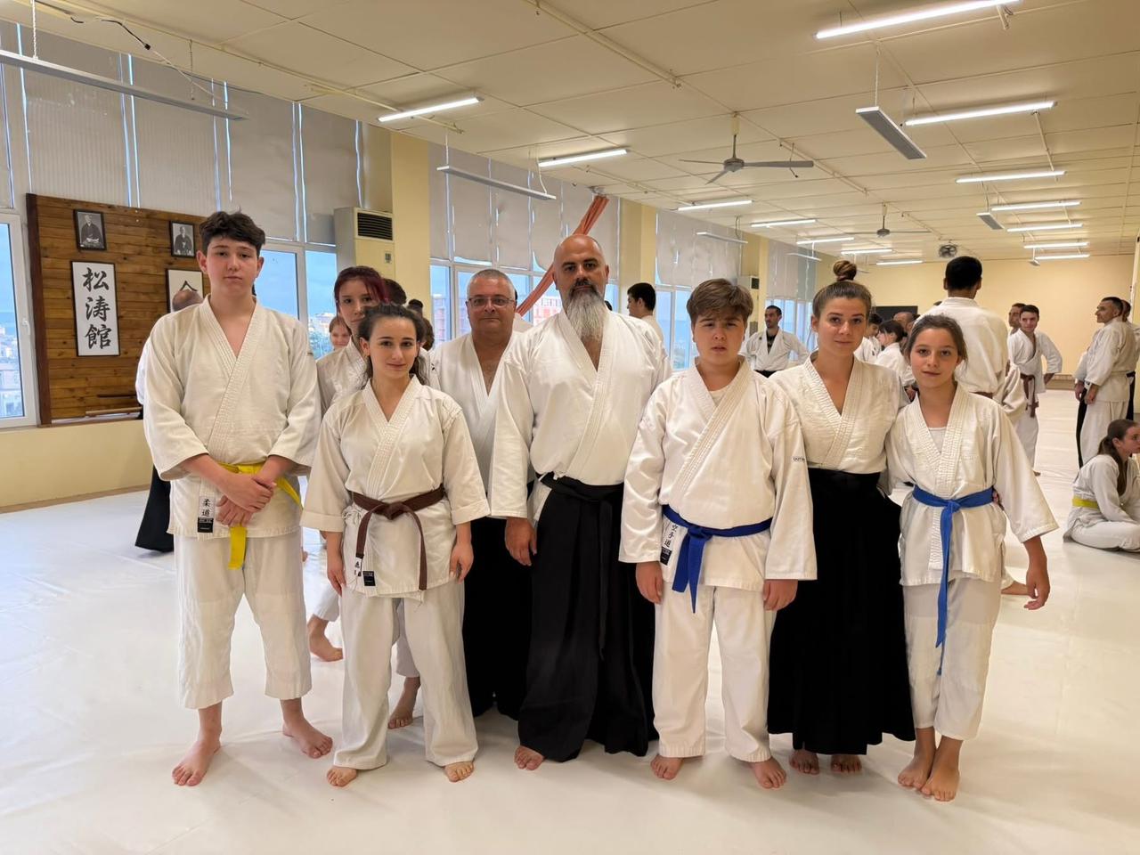 Seven Aikido students with Sensei Elie Beam at an international seminar